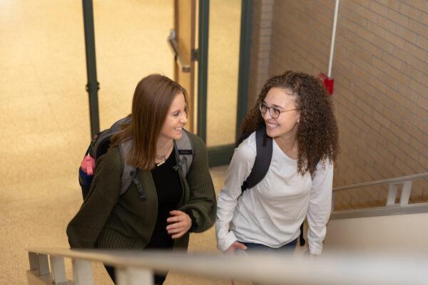 Students walk up stairs to class