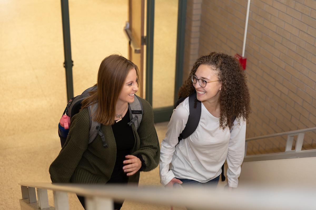 Students walk up stairs to class