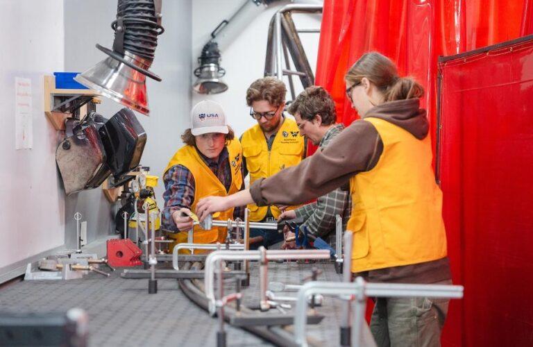 students collaborate on a rail for a competition